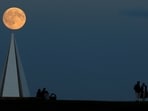 The year's first supermoon appears above the Light Pyramid in Campbell Park, Milton Keynes in Britain.