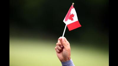 A person holds a Canada flag in Mississauga, Canada. (AFP)
