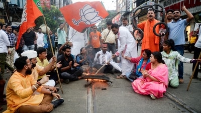 BJP activists protest against the attack on MP Khagen Murmu and MLA Shankar Ghosh during their visit to the flood-hit Doars Nagrakata area in Kolkata. (ANI)
