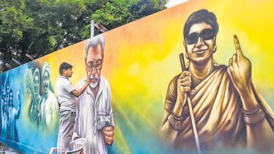 An artist paints a mural depicting voters ahead of the Bihar assembly elections, in Patna, on Tuesday. (PTI)