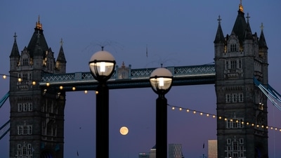 The Harvest Supermoon rises behind Tower Bridge on Monday, October 6, 2025, in London. (Julia Demaree Nikhinson/AP)