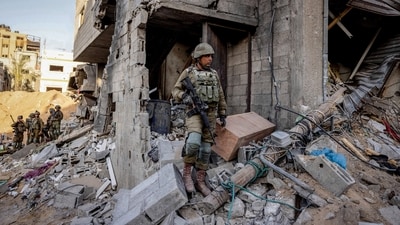 Israeli soldiers stand amid rubble, during the ongoing ground invasion against Palestinian group Hamas in the northern Gaza Strip (REUTERS)