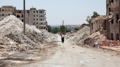 A man walks through the destruction in the city of Aleppo, Syria (REUTERS)