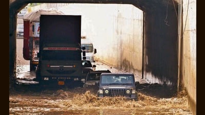 Vehicles struggle through a flooded underpass near Verka Milk plant in Ludhiana on Tuesday. (Gurpreet Singh/HT)