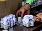 Chhindwara: The Drugs Department sealing the Coldrif cough syrup containers after 10 children allegedly die due to consuming it during raid in an Ayush firm, in Chhindwara. (ANI Video Grab). 
 