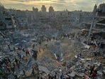 Palestinians search for casualties at the site of Israeli strikes on houses in Jabalia refugee camp in the northern Gaza Strip, October 31, 2023.