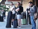 People stand outside Hollywood Burbank Airport on October 6.(Getty Images via AFP)