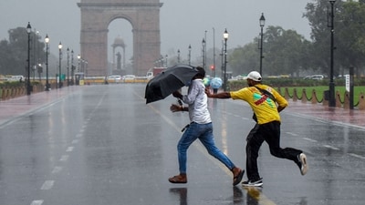 People enjoy the rain at Kartavya Path, in New Delhi on Tuesday. (ANI) People enjoy the rain at Kartavya Path, in New Delhi on Tuesday. (ANI)