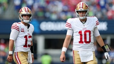 Brock Purdy #13 and Mac Jones #10 of the San Francisco 49ers looks on during the third quarter against the Seattle Seahawks (Getty Images via AFP) Brock Purdy #13 and Mac Jones #10 of the San Francisco 49ers looks on during the third quarter against the Seattle Seahawks (Getty Images via AFP)