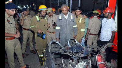 Police officials and firefighters inspect the damaged vehicles at the site after the blasts in Kanpur on Wednesday. (ANI Photo) Police officials and firefighters inspect the damaged vehicles at the site after the blasts in Kanpur on Wednesday. (ANI Photo)