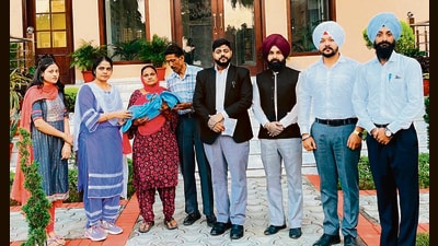 The infant with his grandparents in Ludhiana. (HT Photo) The infant with his grandparents in Ludhiana. (HT Photo)