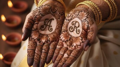 Mehendi featuring personalized initials of the couple integrated into a floral design. Mehendi featuring personalized initials of the couple integrated into a floral design. 