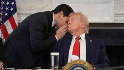 Secretary of State Marco Rubio whispers to President Donald Trump, who is holding the note Rubio handed to him, during a roundtable meeting on antifa in the State Dining Room at the White House (AP)
