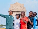Birhanu Legese takes a selfie with other elite runners for Vedanta Delhi Half Marathon. (HT)