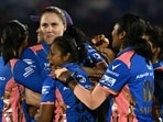 Nat Sciver-Brunt celebrates with teammates after taking the wicket of Delhi Capitals' Shikha Pandey.