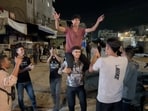 Palestinians celebrate on a street following the news that Israel and Hamas have agreed on Wednesday to the first phase of U.S. President Donald Trump's plan for Gaza, in Khan Younis 