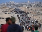 Displaced Palestinians gather on the coastal road near Wadi Gaza after the announcement that Israel and Hamas had agreed to the first phase of a peace plan to pause the fighting