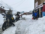 People ride their motorcycles through a snow-covered road at Sissu, in Lahaul -Spiti on Wednesday. (PTI) People ride their motorcycles through a snow-covered road at Sissu, in Lahaul -Spiti on Wednesday. (PTI)