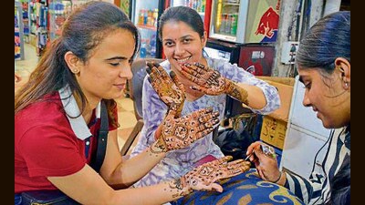 A woman gets henna applied on her hands on the eve of Karwa Chauth in Ludhiana on Thursday. (Gurpreet Singh/HT) A woman gets henna applied on her hands on the eve of Karwa Chauth in Ludhiana on Thursday. (Gurpreet Singh/HT)