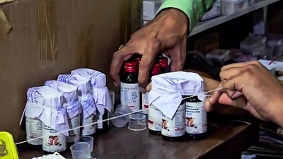 Chhindwara, Oct 5 (ANI): The Drugs Department sealing the Coldrif cough syrup containers after 10 children allegedly die due to consuming it during raid in an Ayush firm, in Chhindwara on Sunday. (ANI Video Grab). (ANI Video Grab) Chhindwara, Oct 5 (ANI): The Drugs Department sealing the Coldrif cough syrup containers after 10 children allegedly die due to consuming it during raid in an Ayush firm, in Chhindwara on Sunday. (ANI Video Grab). (ANI Video Grab)