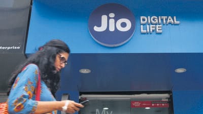 FILE PHOTO: A woman checks her mobile phone as she walks past a mobile store of Reliance Industries' Jio telecoms unit, in Mumbai, India, July 11, 2017. REUTERS/Shailesh Andrade/File Photo (REUTERS) FILE PHOTO: A woman checks her mobile phone as she walks past a mobile store of Reliance Industries' Jio telecoms unit, in Mumbai, India, July 11, 2017. REUTERS/Shailesh Andrade/File Photo (REUTERS)