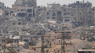 Israeli troops walk through the Gaza Strip as seen from southern Israel. (Ohad Zwigenberg/AP) Israeli troops walk through the Gaza Strip as seen from southern Israel. (Ohad Zwigenberg/AP)