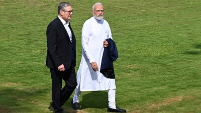 British Prime Minister Sir Keir Starmer and Indian Prime Minister Narendra Modi walk through the gardens at Raj Bhavan on October 9 in Mumbai (Reuters)