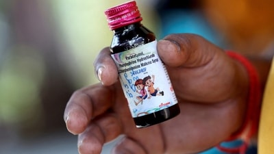 Nilesh Suryavanshi, 32, the father of a 3 year old child who has been admitted at the Government Medical College, holds a bottle of Coldrif cough syrup. (REUTERS)
