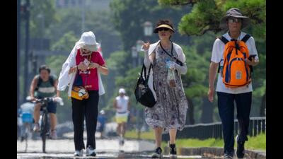 Tourists walk in the hot sun on a sidewalk near the Imperial Palace in Tokyo, Japan. (AFP) Tourists walk in the hot sun on a sidewalk near the Imperial Palace in Tokyo, Japan. (AFP)