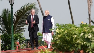 Prime Minister Sir Keir Starmer and PM Modi walk through the gardens at Raj Bhavan, in Mumbai, on Thursday. (Reuters)