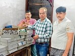 District health department officials collect sweets and dairy products samples from local markets amid festive season in Ludhiana on Friday. (HT Photo)