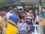 Students helping a fellow student as they gather outside the school buildings after an earthquake in Davao de Oro, Mindanao. 