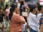 A woman hugs a child as parents and children evacuate a school after a strong earthquake in Davao City, Philippines.