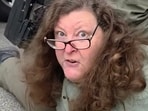 The video showed masked border patrol agents holding a woman, who identifies herself as Debbie Brockman, to the ground.