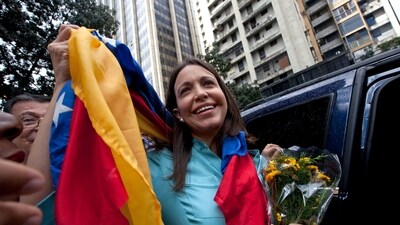 Former Congresswoman and opposition leader Maria Corina Machado holds up the Venezuelan flag outside of the Attorney General's Office in Caracas, Venezuela, Wednesday, December 3, 2014. (AP File) Former Congresswoman and opposition leader Maria Corina Machado holds up the Venezuelan flag outside of the Attorney General's Office in Caracas, Venezuela, Wednesday, December 3, 2014. (AP File)