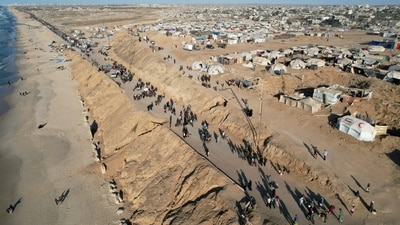 A drone view shows Palestinians, who were displaced to the southern part of Gaza at Israel's order during the war, making their way along a road to return to the north after a ceasefire between Israel and Hamas (Reuters)