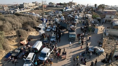 A drone view shows Palestinians, who were displaced to the southern part of Gaza at Israel's order during the war, making their way along a road to return to the north (Reuters)