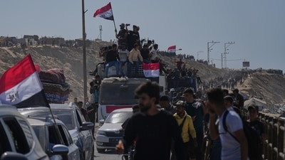 Displaced Palestinians ride on vehicles and wave Egyptian flags as they move along the coastal road in the central Gaza Strip, heading toward Gaza City. (AP) Displaced Palestinians ride on vehicles and wave Egyptian flags as they move along the coastal road in the central Gaza Strip, heading toward Gaza City. (AP)