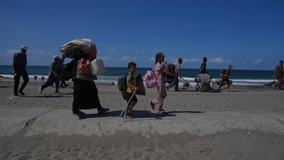 Women and children walk with their belongings towards Gaza City after the ceasefire between Israel and Hamas was announced. (AP) Women and children walk with their belongings towards Gaza City after the ceasefire between Israel and Hamas was announced. (AP)