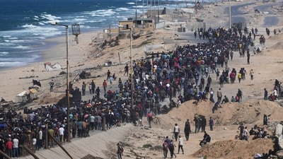 Displaced Palestinians walk toward northern Gaza after Israel and Hamas agreed to a pause in their war and the release of the remaining hostages. (AP) Displaced Palestinians walk toward northern Gaza after Israel and Hamas agreed to a pause in their war and the release of the remaining hostages. (AP)