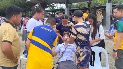 Students helping a fellow student as they gather outside the school buildings after an earthquake in Davao de Oro, Mindanao. (AFP) Students helping a fellow student as they gather outside the school buildings after an earthquake in Davao de Oro, Mindanao. (AFP)