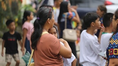 A woman hugs a child as parents and children evacuate a school after a strong earthquake in Davao City, Philippines. (AP) A woman hugs a child as parents and children evacuate a school after a strong earthquake in Davao City, Philippines. (AP)