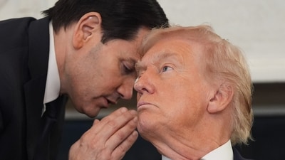 Secretary of State Marco Rubio whispers to President Donald Trump. (AP)