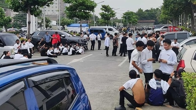 Employees at a shopping mall gather outside the building in Davao City after the earthquake. (AFP) Employees at a shopping mall gather outside the building in Davao City after the earthquake. (AFP)