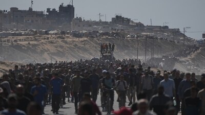 Displaced Palestinians walk with their belongings along the coastal road near Wadi Gaza in the central Gaza Strip, moving toward Gaza City. (AP) Displaced Palestinians walk with their belongings along the coastal road near Wadi Gaza in the central Gaza Strip, moving toward Gaza City. (AP)