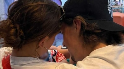In the new picture, the couple is seen smiling at their baby, whose tiny hand is visible in the frame.mi (@milliebobbybrown/Instagram) In the new picture, the couple is seen smiling at their baby, whose tiny hand is visible in the frame.mi (@milliebobbybrown/Instagram)