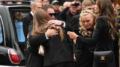 Family members shared emotional embraces outside Manchester Cathedral during the funeral of the late British boxing legend Ricky Hatton. (AFP)