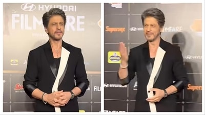 Shah Rukh Khan was seen wearing a black suit accentuated with a bold white panel. Shah Rukh Khan was seen wearing a black suit accentuated with a bold white panel.