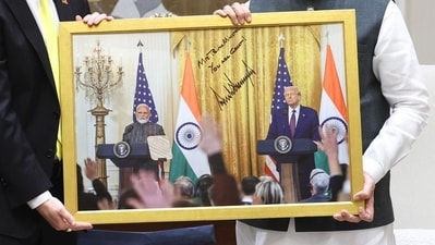 The framed photo that Sergio Gor presented to PM Narendra Modi with President Donald Trump and his message also in it, on Saturday, October 11. (X/@narendramodi) The framed photo that Sergio Gor presented to PM Narendra Modi with President Donald Trump and his message also in it, on Saturday, October 11. (X/@narendramodi)