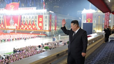 In a photo released by North Korea, the country’s leader Kim Jong Un waves to a crowd during a military parade in Pyongyang. (NK) In a photo released by North Korea, the country’s leader Kim Jong Un waves to a crowd during a military parade in Pyongyang. (NK)